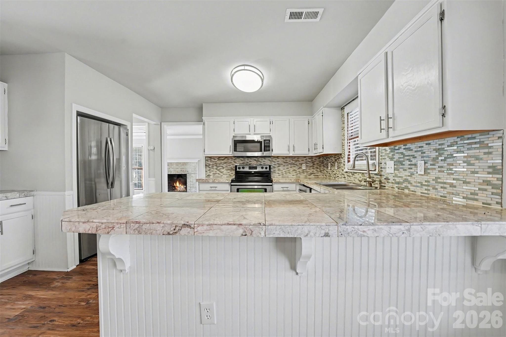 1635 Bear Mountain Road Charlotte, NC 28214 - Photo 15 of 27 a kitchen with stainless steel appliances granite countertop a stove a sink and a granite counter tops