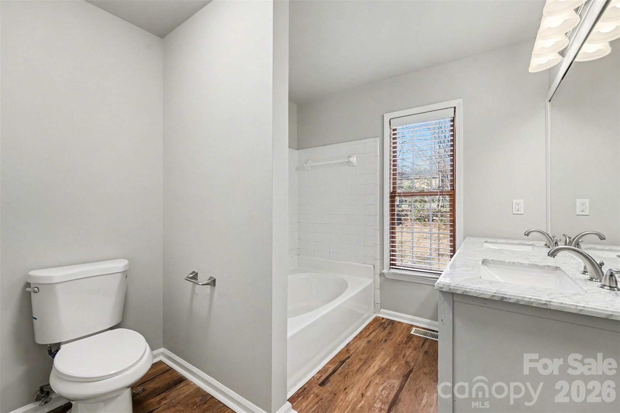 1635 Bear Mountain Road Charlotte, NC 28214 - Photo 16 of 27 a bathroom with a granite countertop toilet a sink and bathtub