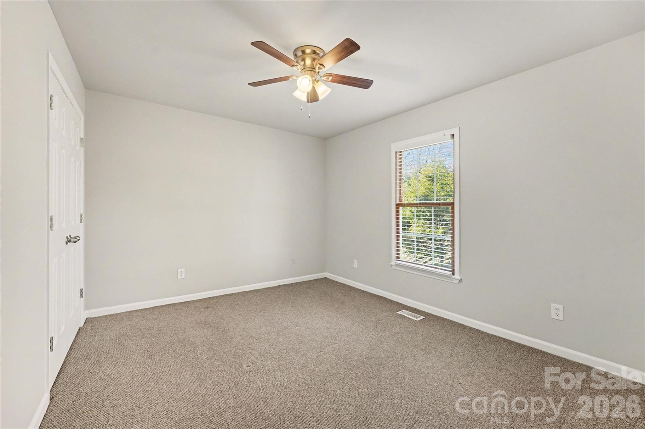 1635 Bear Mountain Road Charlotte, NC 28214 - Photo 18 of 27 an empty room with ceiling fan and window