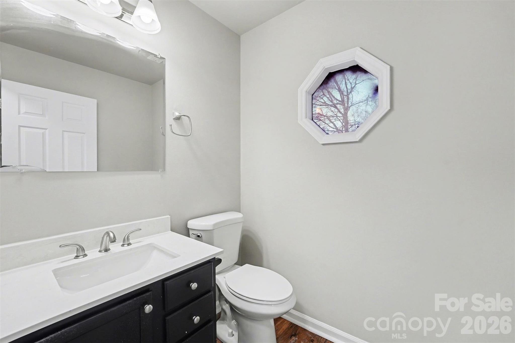 1635 Bear Mountain Road Charlotte, NC 28214 - Photo 20 of 27 a bathroom with a toilet sink and mirror