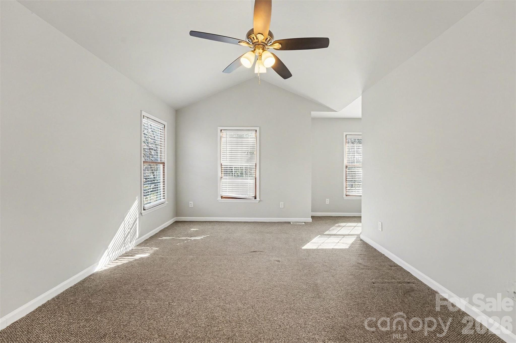 1635 Bear Mountain Road Charlotte, NC 28214 - Photo 21 of 27 an empty room with windows and fan