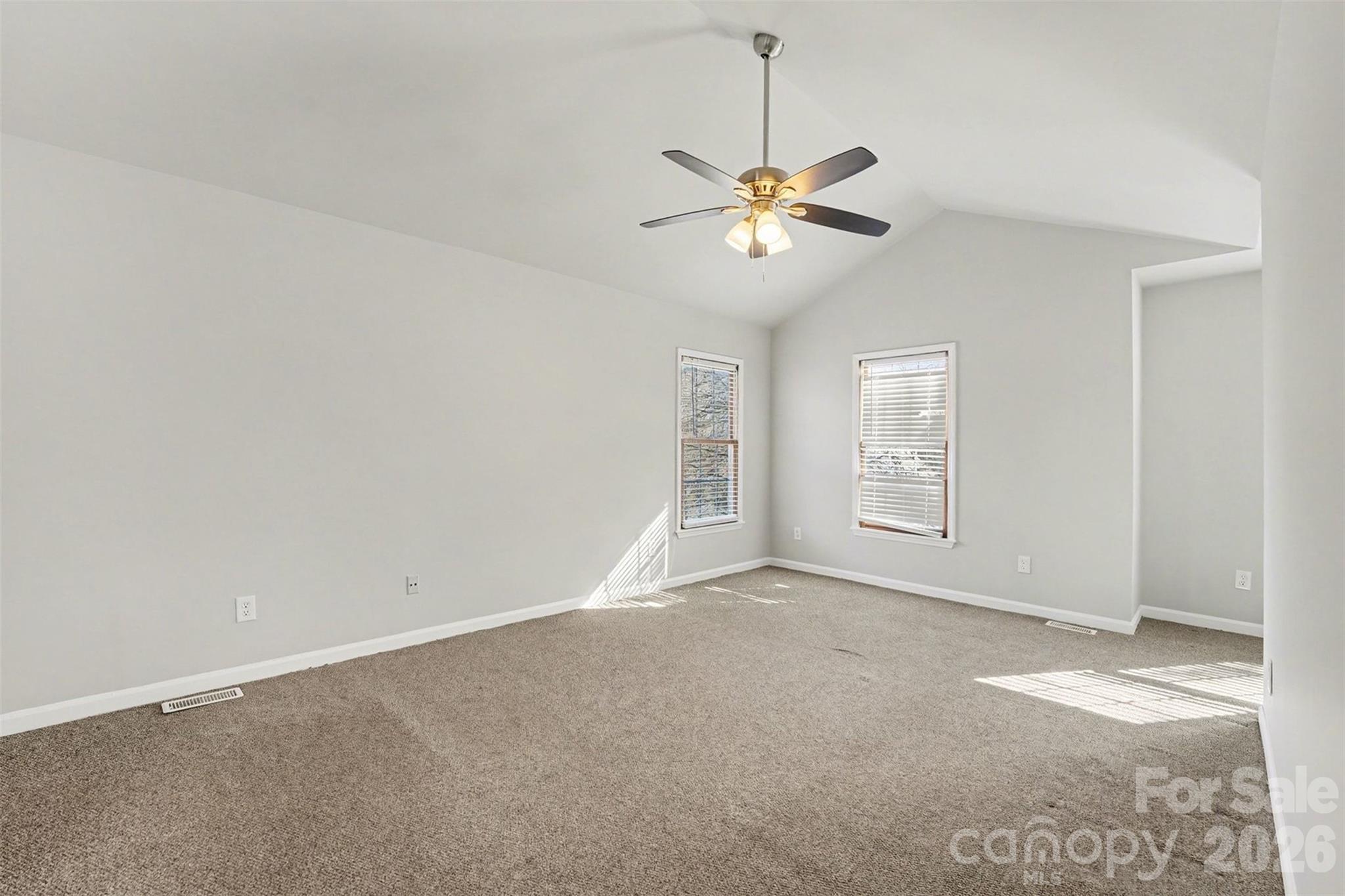 1635 Bear Mountain Road Charlotte, NC 28214 - Photo 4 of 27 an empty room with windows and fan