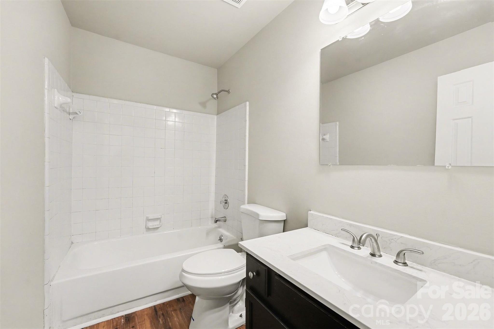 1635 Bear Mountain Road Charlotte, NC 28214 - Photo 5 of 27 a bathroom with a sink a toilet a shower and a mirror