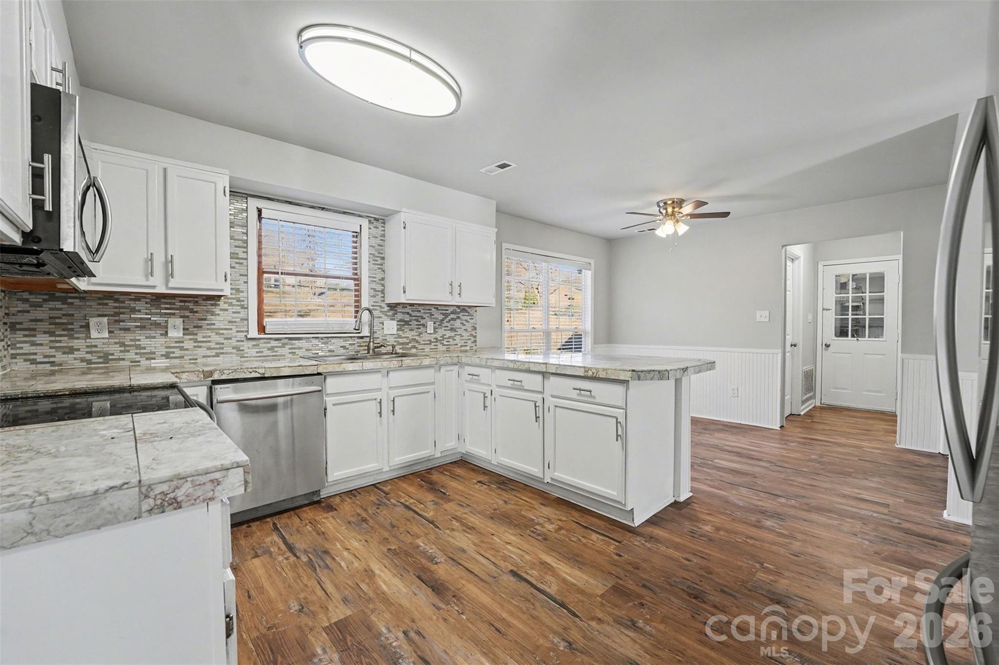 1635 Bear Mountain Road Charlotte, NC 28214 - Photo 8 of 27 a kitchen with a sink cabinets and wooden floor