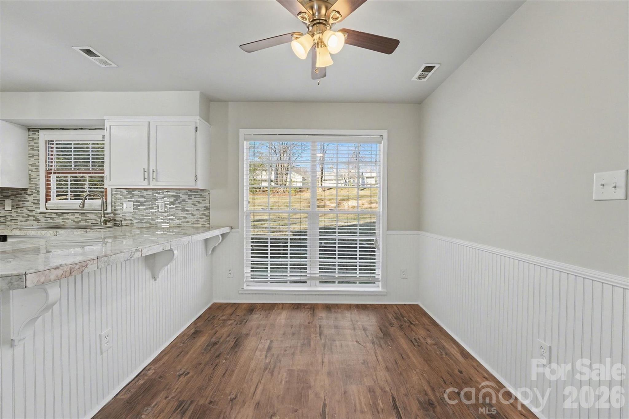 1635 Bear Mountain Road Charlotte, NC 28214 - Photo 9 of 27 wooden floor in an empty room with a window