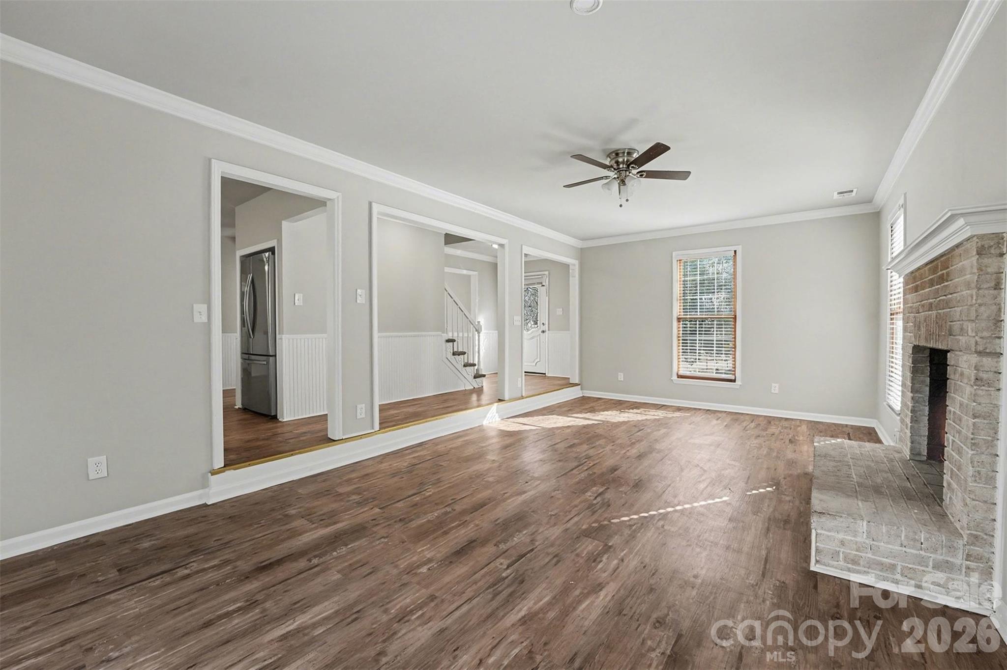 1635 Bear Mountain Road Charlotte, NC 28214 - Photo 10 of 27 wooden floor in an empty room with a window