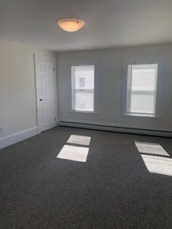 an empty room with a empty space and windows