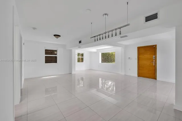 a view of a patio with table and chairs and potted plants