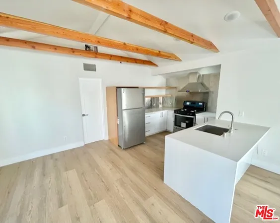 a kitchen view with a sink a refrigerator and a stove