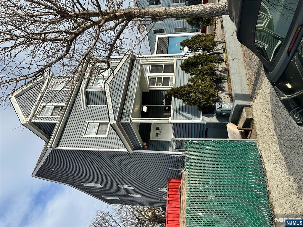 a view of a house with backyard and sitting area
