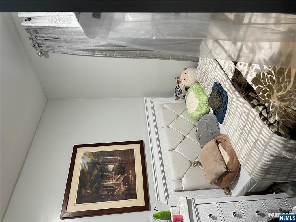 267 Ellison Street Paterson, NJ 07501 - Photo 16 of 16 a bedroom with a bed and a painting on the wall