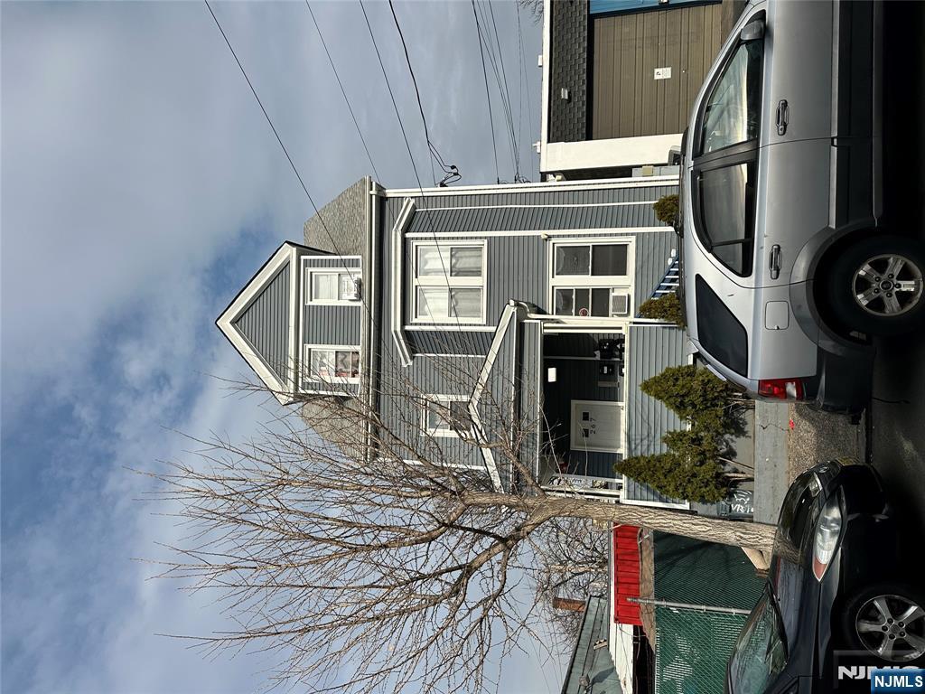 267 Ellison Street Paterson, NJ 07501 - Photo 2 of 16 a front view of a house with parking space