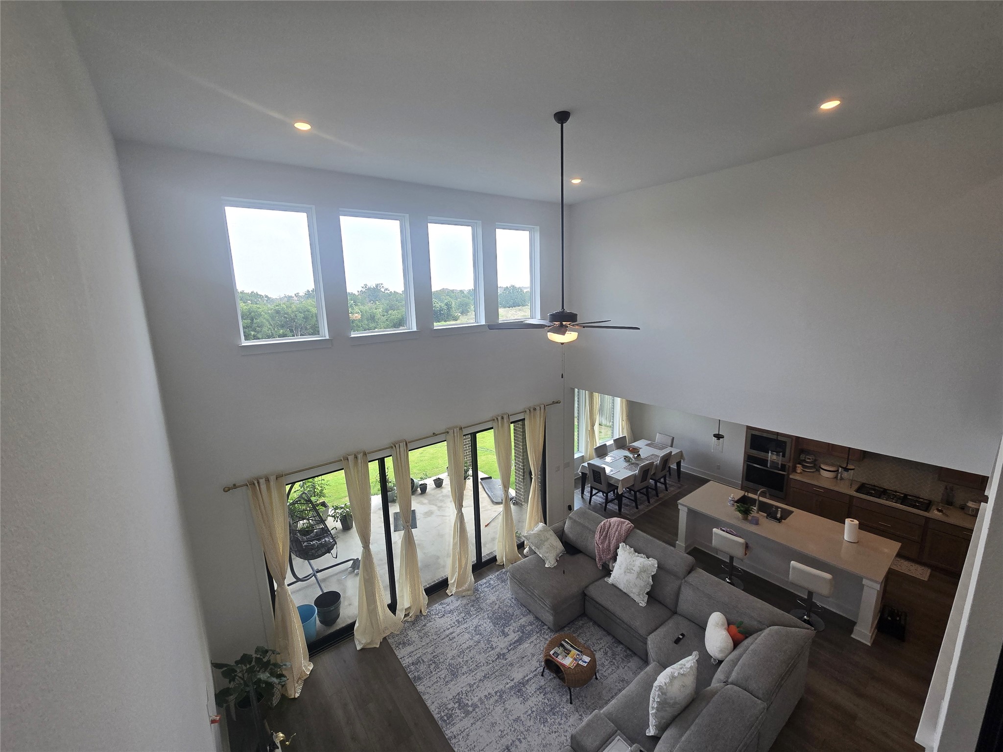 124 Ribera Drive Liberty Hill, TX 78642 - Photo 17 of 40 Natural light floods this living area through a wall of windows, showcasing the open-concept layout.
