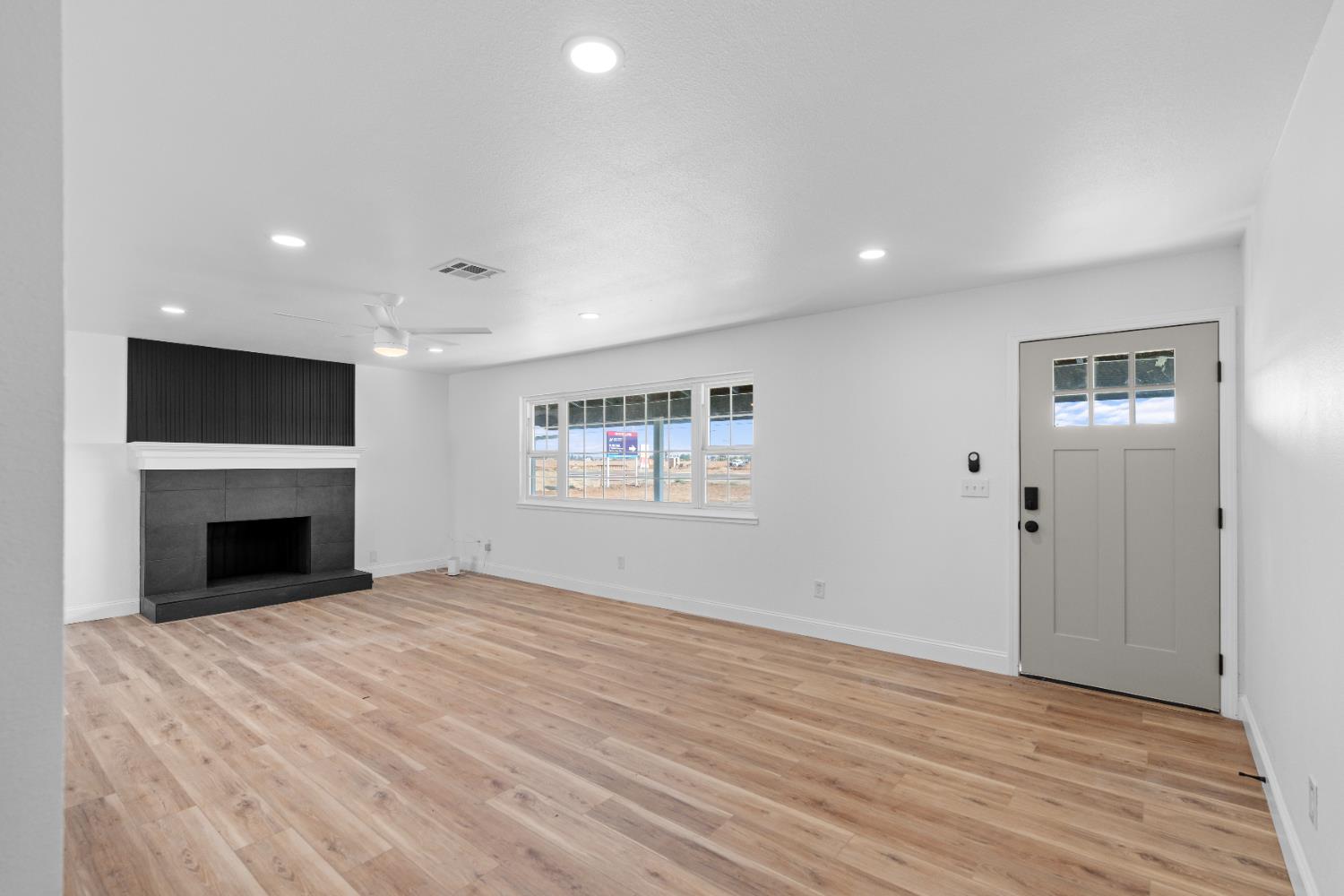 420 Bellevue Road Merced, CA 95348 - Photo 20 of 75 a view of empty room with wooden floor and fireplace