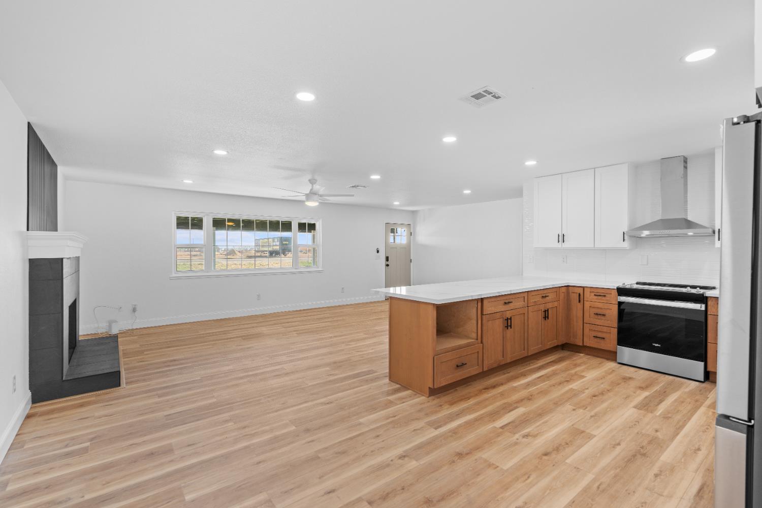 420 Bellevue Road Merced, CA 95348 - Photo 31 of 75 a large kitchen with wooden floors and white stainless steel appliances