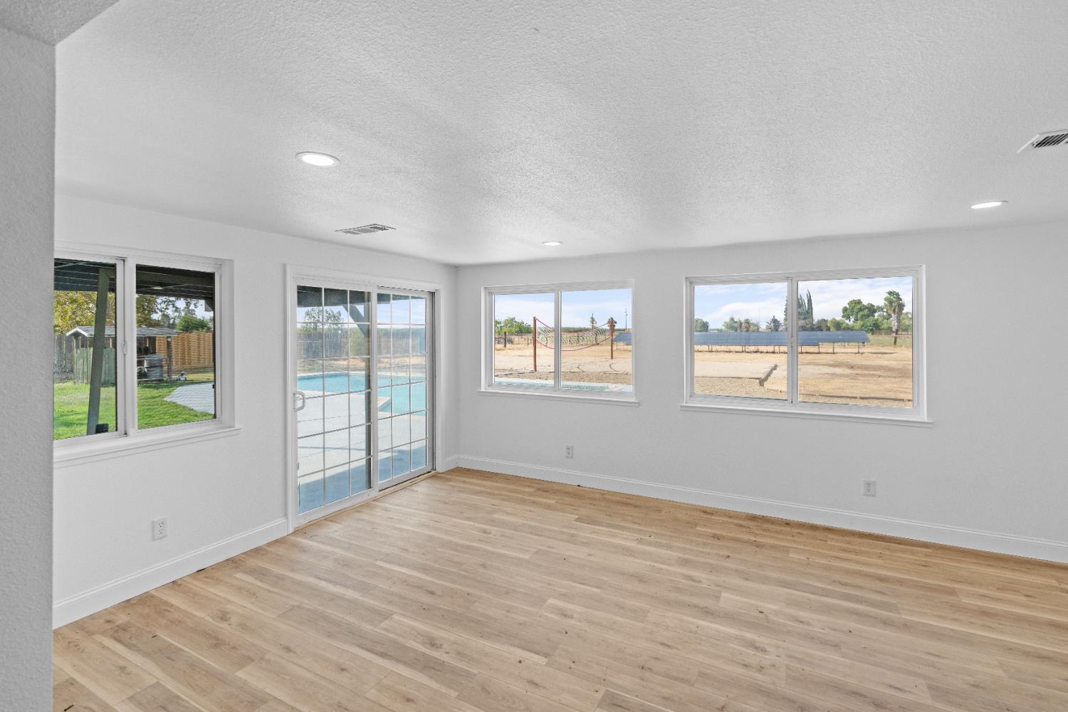 420 Bellevue Road Merced, CA 95348 - Photo 35 of 75 a view of an empty room with wooden floor and a window