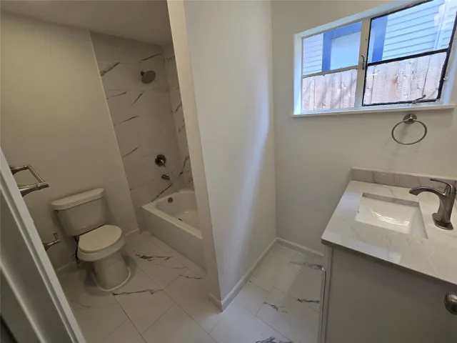 a bathroom with a sink toilet and vanity