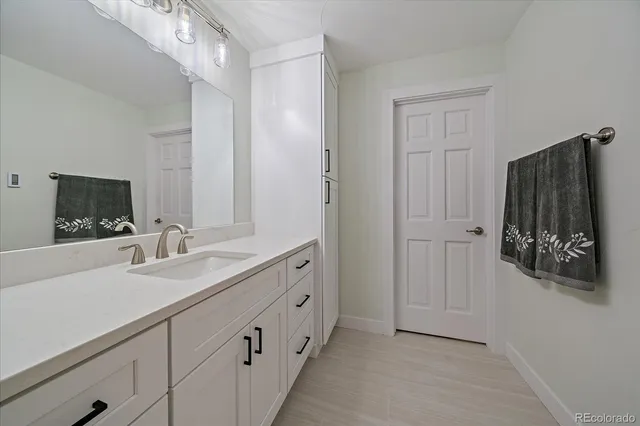 a bathroom with a double vanity sink and mirror