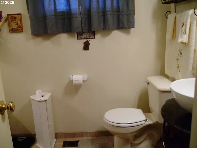 a white toilet sitting next to a bathroom sink