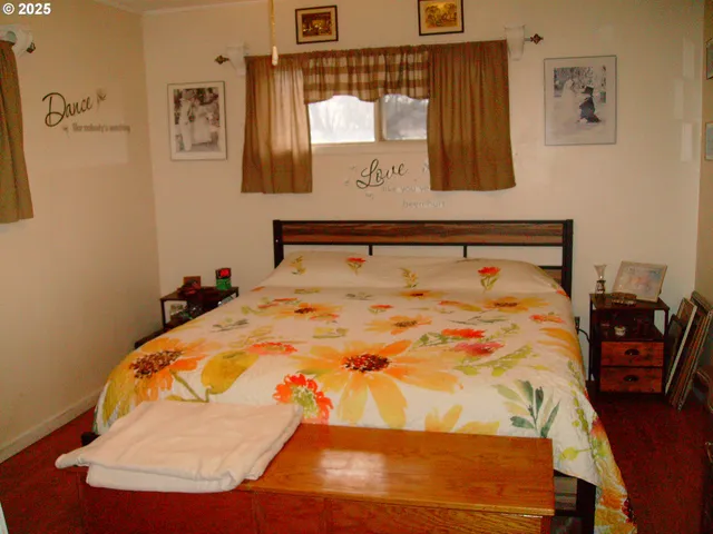 a bed sitting in a bedroom next to a window