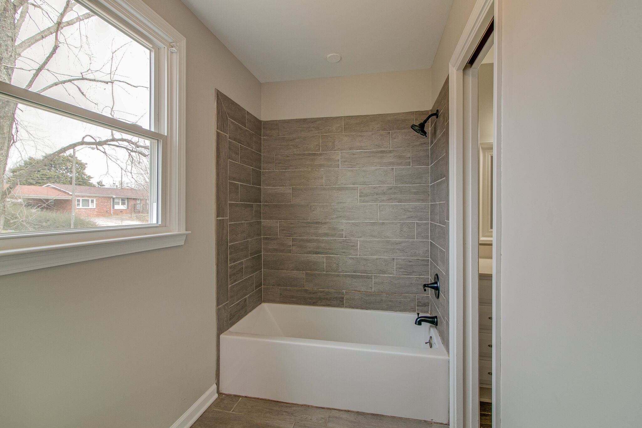 310 Burch Road Clarksville, TN 37042 - Photo 21 of 30 a bathroom with a bathtub and window