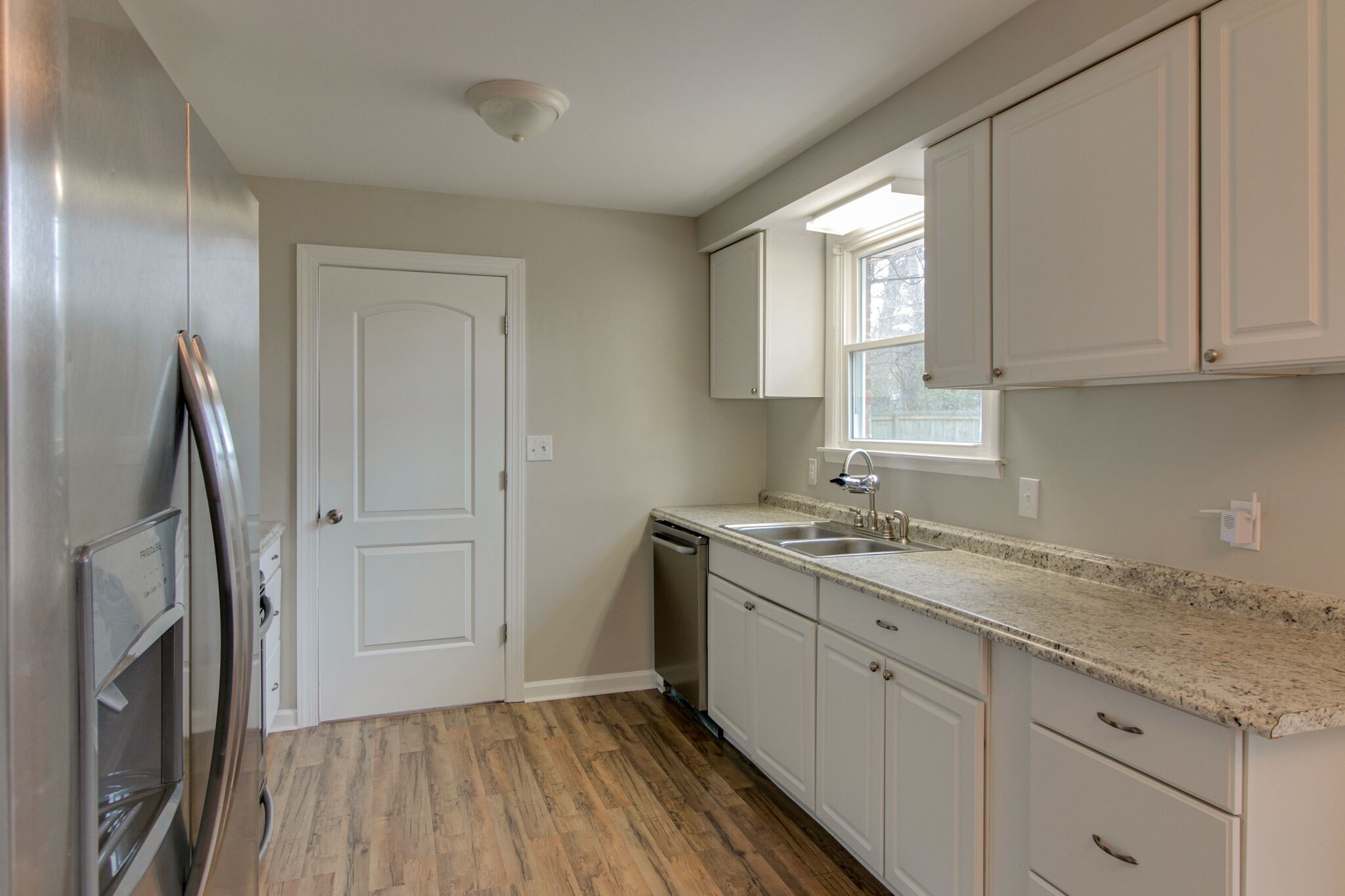 310 Burch Road Clarksville, TN 37042 - Photo 10 of 30 a kitchen with a sink a window and cabinets