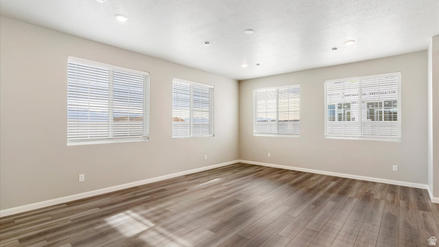 82 Provo River Road, Unit 251 Saratoga Springs, UT 84045 - Photo 5 of 32 Spacious room with wood-finish flooring, light neutral wall tones, multiple windows with blinds, and recessed ceiling lighting