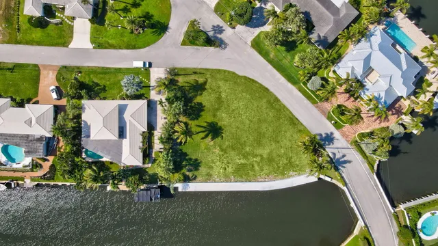 an aerial view of a house with a garden and swimming pool
