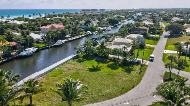 an aerial view of residential houses with outdoor space and lake view