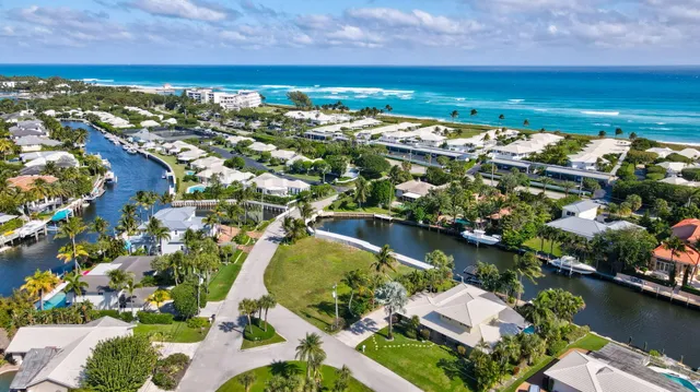 an aerial view of ocean residential house with outdoor space and trees all around