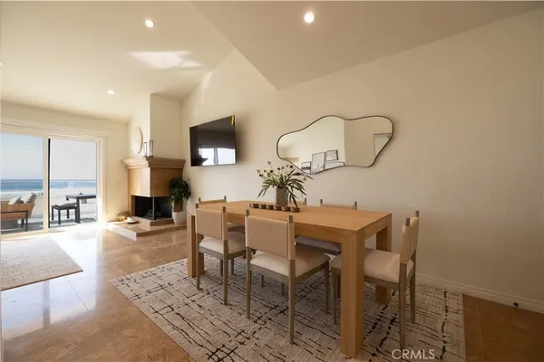 a dining room with furniture and a chandelier