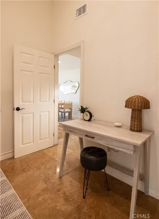 a room with a table chairs and entryway