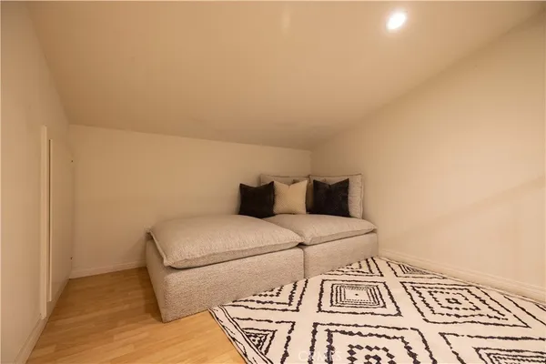 a bed sitting in a bedroom next to a window