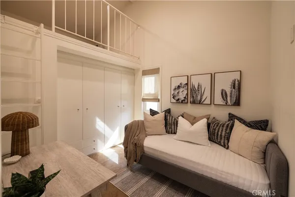 a bedroom with furniture and a painting
