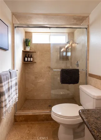 a bathroom with a toilet a sink and shower
