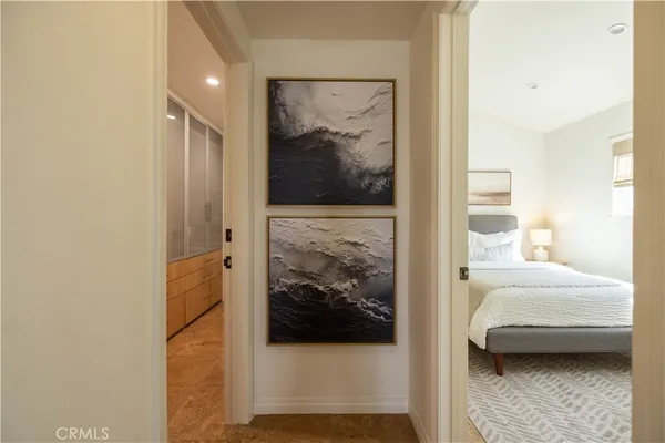 a view of a bedroom with a bed and wooden floor