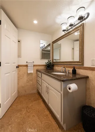 a bathroom with a sink a toilet and mirror