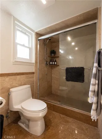 a bathroom with a toilet and a shower