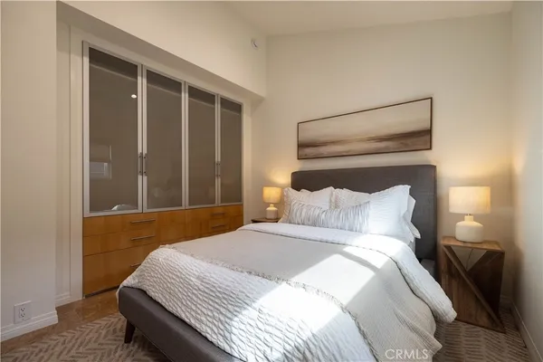 a bedroom with a bed and a night stand