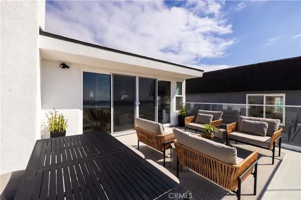 a balcony with wooden floor and furniture