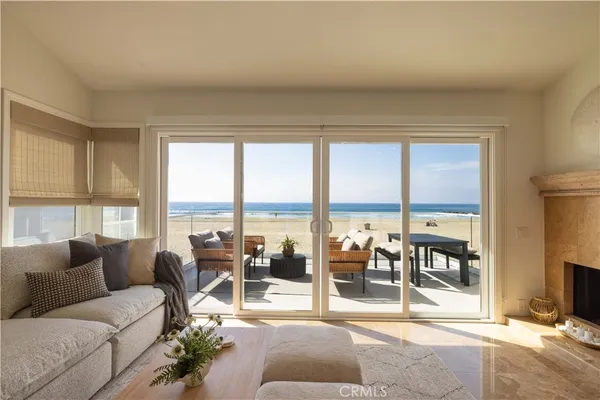 a living room with furniture and a floor to ceiling window