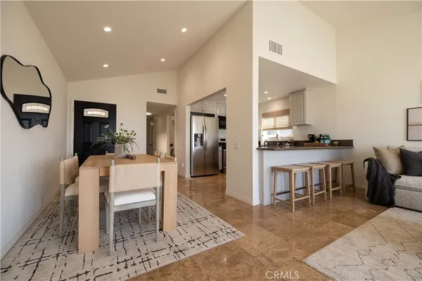 a dining room with furniture and a kitchen view