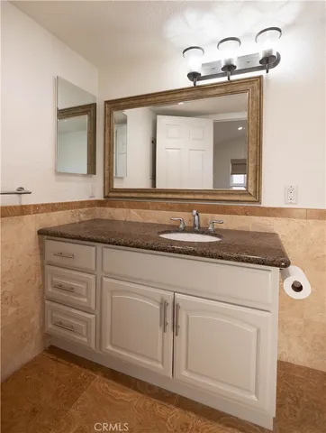 a sink with white cabinets