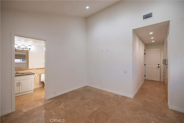 an empty room with a bathroom and a sink
