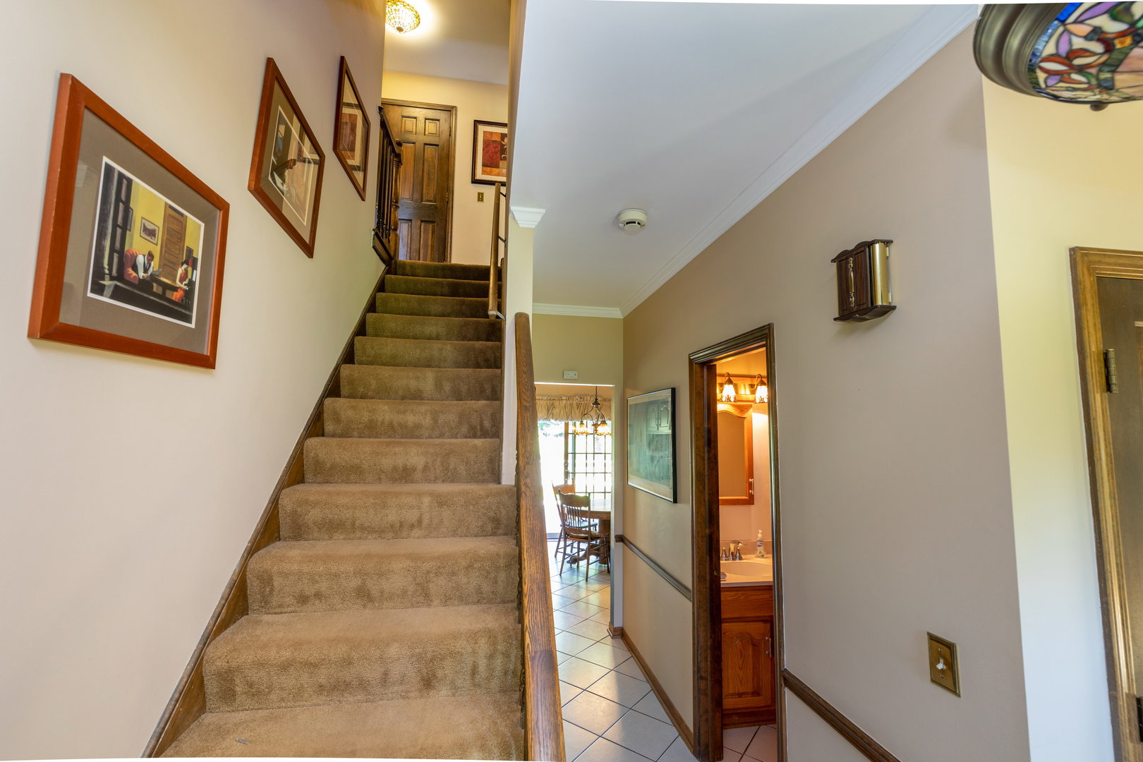 1 Cross Timber Road Barrington, IL 60010 - Photo 25 of 53 a view of staircase with lots of frames on wall and a window