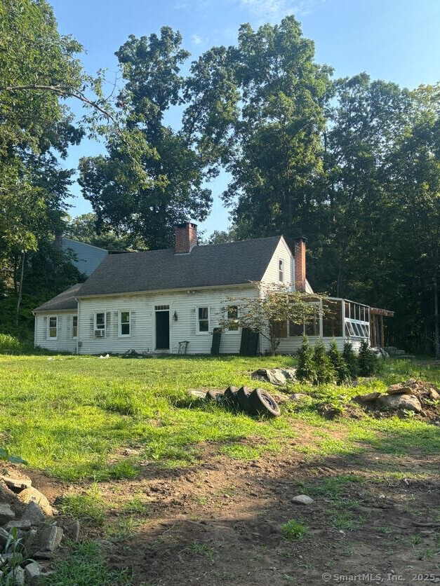 a front view of house with yard and green space