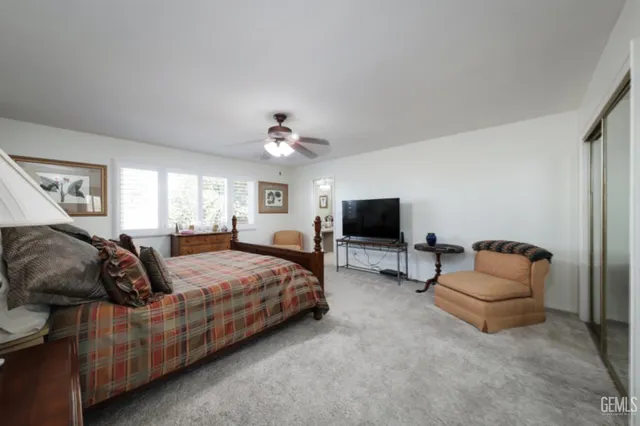 a bedroom with a bed and a television