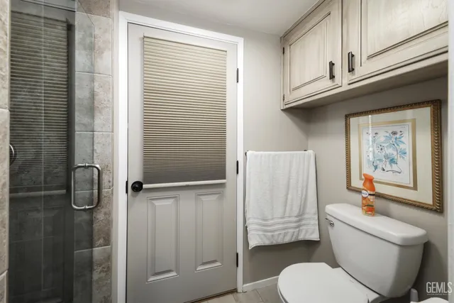 a white toilet sitting next to a bathroom sink