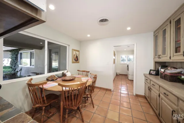 a dining room with furniture and window