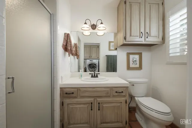 a bathroom with a sink a toilet and a mirror
